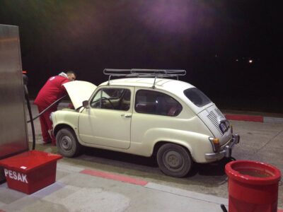 Nikola pumping gas into a Fićo (Serbia, Fall '16) --- note to self: project idea: document what happens overnight at gas stations around the world!