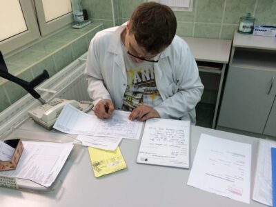 the doctor who saw me at the Pomeranian Center for Infectious Diseases and Tuberculosis in Gdańsk, Poland, dealing with the underlying paperwork (June 19th, '17)