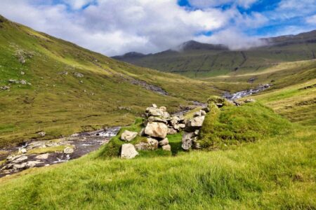 many hiking trails in the Faroe Islands are old postal routes from before some of their modern roads and tunnels were built — this is a decaying wind shelter in one of them